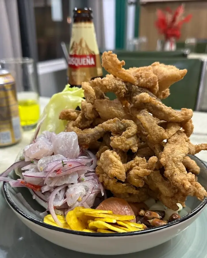 Ceviche carretillero topped with crispy fried fish, served with a cold Cusqueña at Ají & Limón in Adelaide