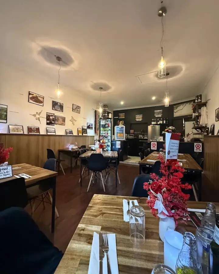 The warm wooden dining room of Ají & Limón in Brooklyn Park, set for dinner